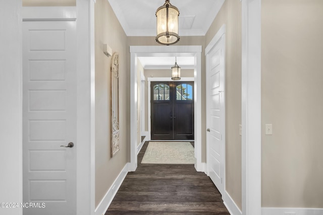 doorway to outside with dark hardwood / wood-style flooring and crown molding