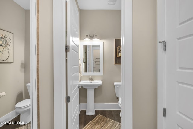 bathroom featuring wood-type flooring and toilet