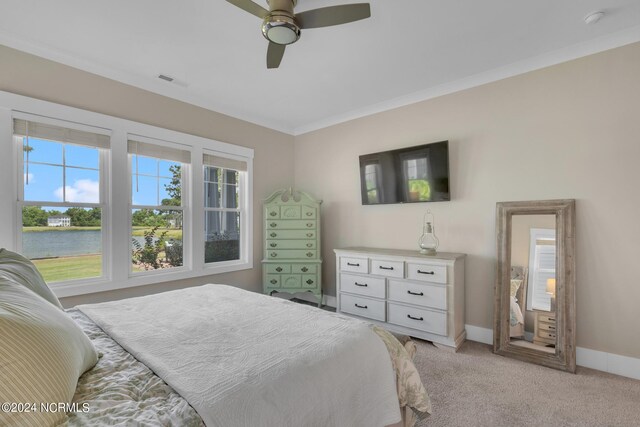 bedroom with ornamental molding, light colored carpet, ceiling fan, and a water view