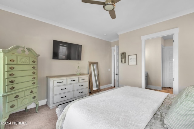 bedroom with connected bathroom, crown molding, light colored carpet, and ceiling fan