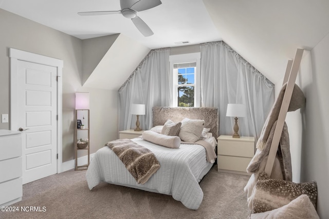 carpeted bedroom with ceiling fan and vaulted ceiling