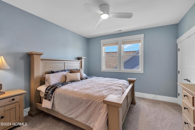 bedroom with light carpet and ceiling fan