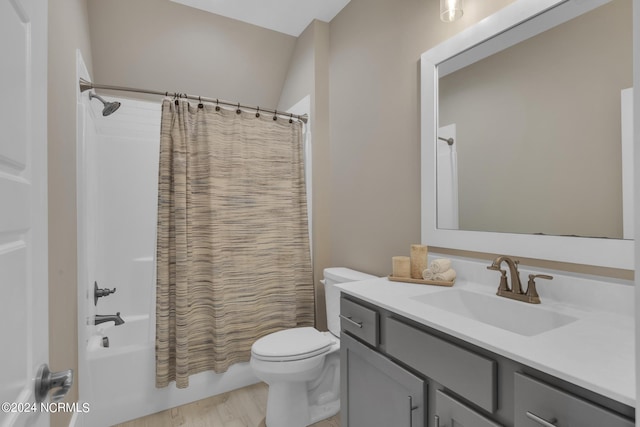 full bathroom with shower / tub combo, vanity, wood-type flooring, and toilet