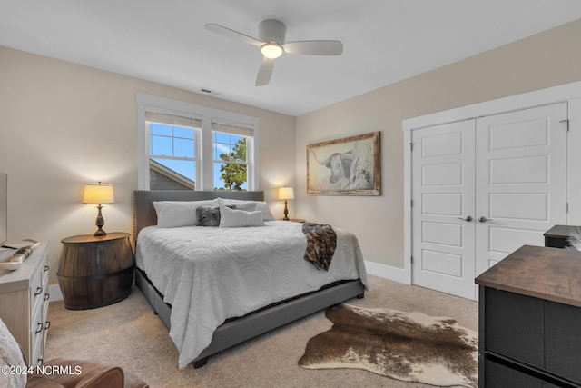 carpeted bedroom with a closet and ceiling fan