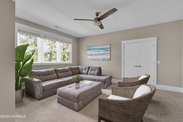 carpeted living room featuring ceiling fan