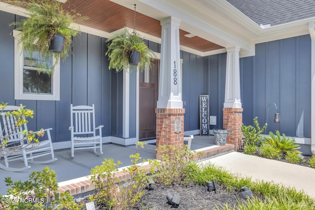 view of exterior entry featuring covered porch