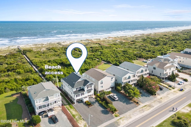 drone / aerial view with a beach view and a water view