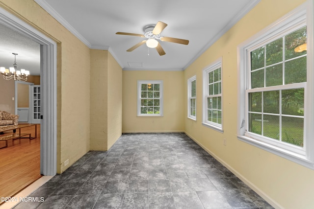 interior space with ceiling fan with notable chandelier and ornamental molding