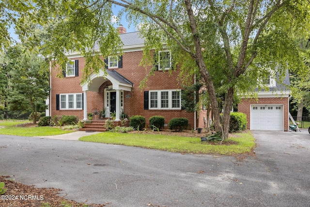 view of front of home featuring a garage and a front lawn