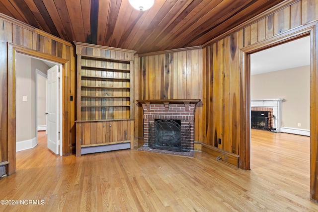 unfurnished living room featuring a baseboard heating unit, wood ceiling, a fireplace, and light hardwood / wood-style flooring