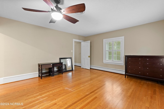 interior space with a baseboard radiator, ceiling fan, and light wood-type flooring