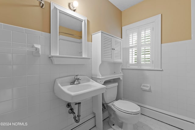 bathroom with tile walls, sink, a baseboard radiator, tile patterned floors, and toilet