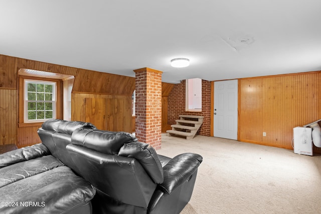 living room featuring light carpet and wood walls