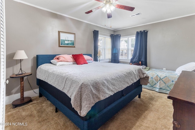 bedroom with ceiling fan, ornamental molding, and light colored carpet