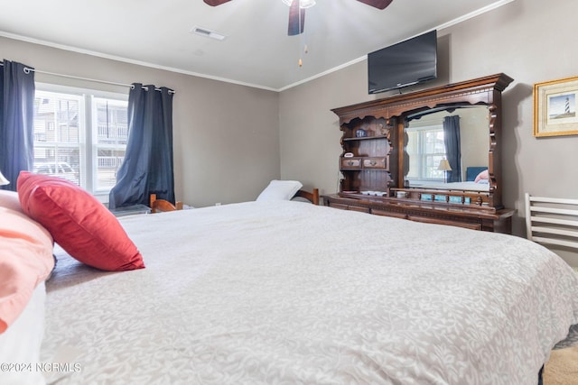 bedroom featuring ceiling fan, visible vents, and crown molding