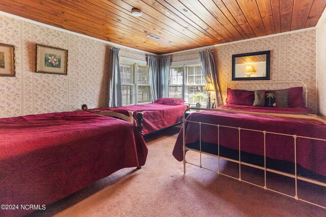 bedroom featuring ornamental molding, carpet floors, and wood ceiling