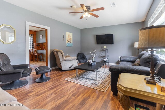 living room with ceiling fan and wood-type flooring