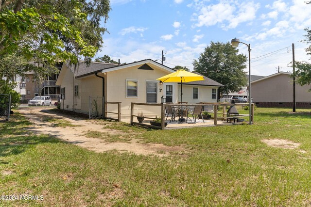 back of house with a lawn and a patio area