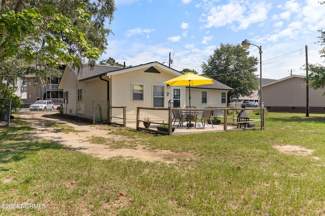 back of property featuring a patio, a lawn, and fence