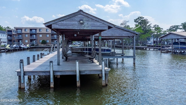 dock area with a water view and boat lift