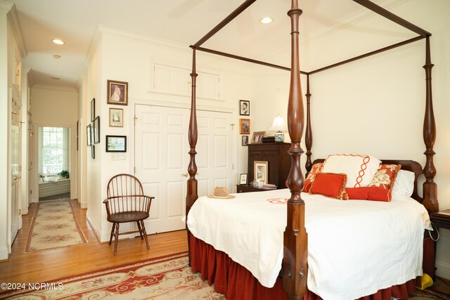 bedroom featuring ornamental molding and hardwood / wood-style flooring