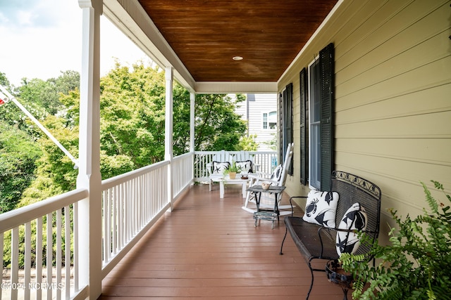 wooden terrace with a porch