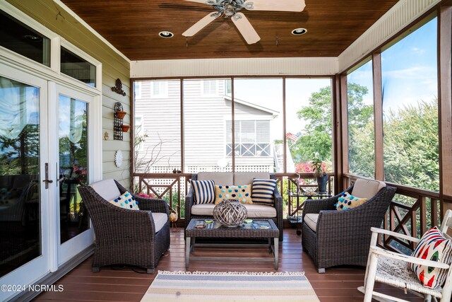 sunroom / solarium with ceiling fan, french doors, and wood ceiling