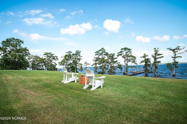 view of yard with a boat dock and a water view