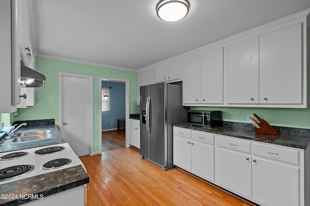 kitchen featuring a sink, stainless steel fridge, white cabinets, and range hood