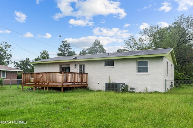 back of property with fence, a deck, central AC, and brick siding