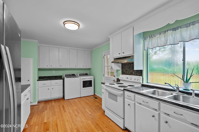 kitchen with white electric range, washer and clothes dryer, white cabinets, stainless steel refrigerator, and light hardwood / wood-style flooring