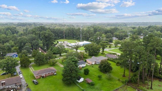 birds eye view of property with a view of trees