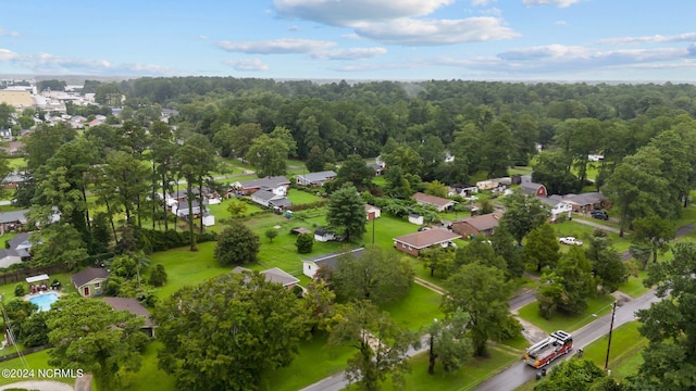 birds eye view of property with a forest view