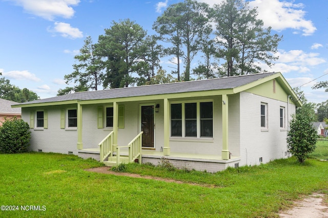 ranch-style house featuring brick siding, crawl space, a porch, and a front lawn