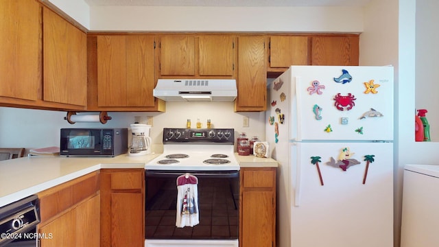 kitchen featuring washer / dryer and white appliances