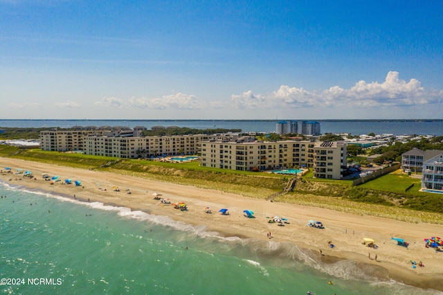 birds eye view of property featuring a water view and a beach view