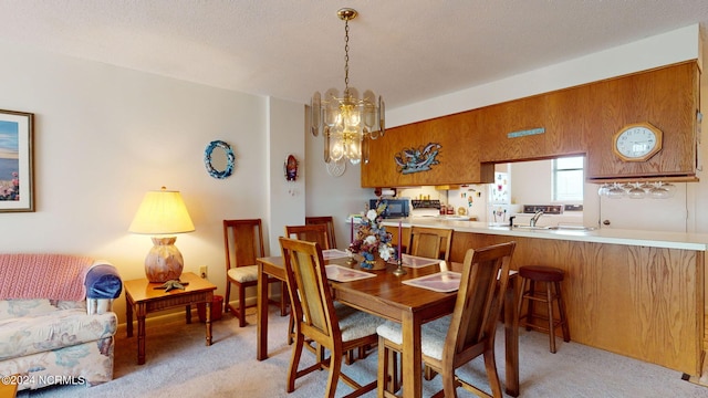 carpeted dining area featuring an inviting chandelier and sink