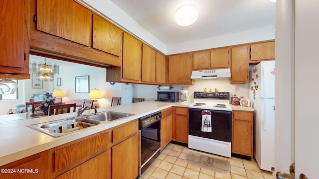 kitchen featuring pendant lighting, black appliances, sink, light tile patterned floors, and a textured ceiling