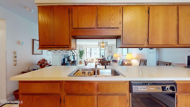 kitchen with kitchen peninsula, dishwashing machine, sink, a notable chandelier, and tile patterned flooring