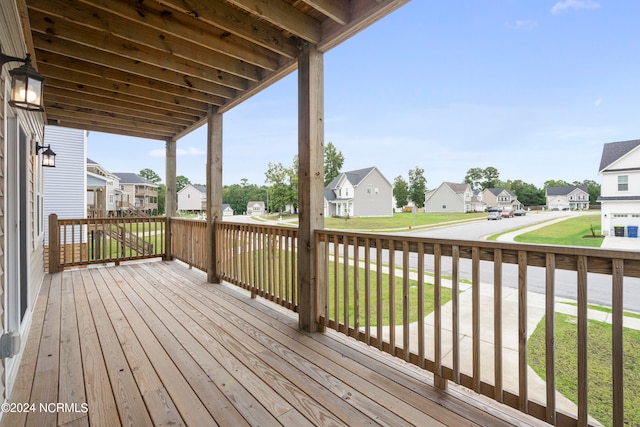 wooden deck with a lawn