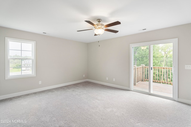 empty room featuring carpet floors and ceiling fan