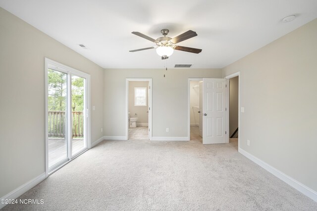 unfurnished bedroom featuring a closet, light carpet, access to exterior, and ceiling fan