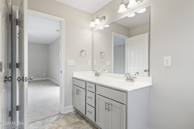 bathroom with double vanity and tile patterned flooring