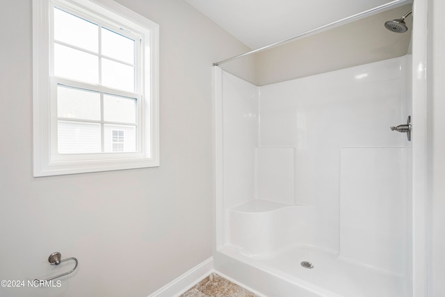 bathroom with tile patterned flooring and a shower