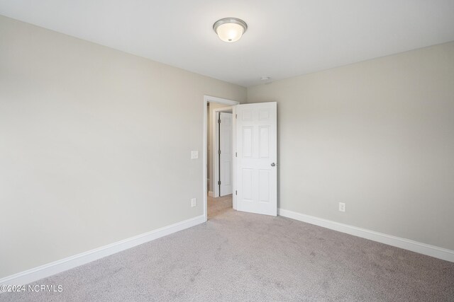 empty room featuring light colored carpet