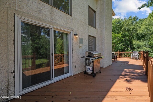 wooden terrace featuring area for grilling