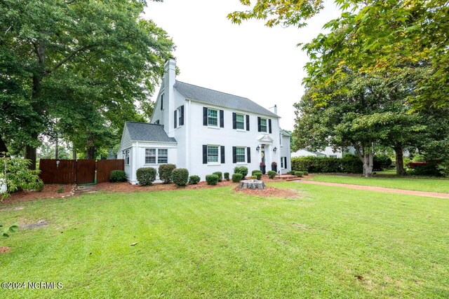 colonial inspired home with a front yard