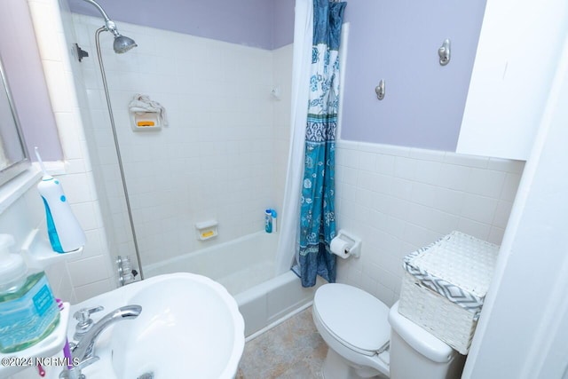 full bathroom featuring sink, tile walls, shower / tub combo with curtain, and toilet