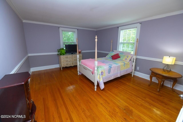 bedroom with wood-type flooring and ornamental molding