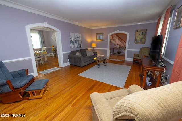 living room with ornamental molding and hardwood / wood-style floors